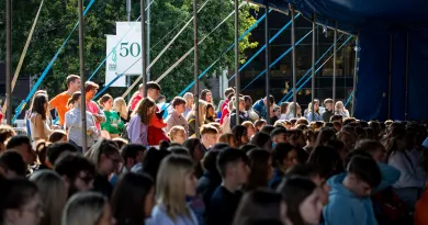 large crowd of students looking into a glass window Orientation day 2022 