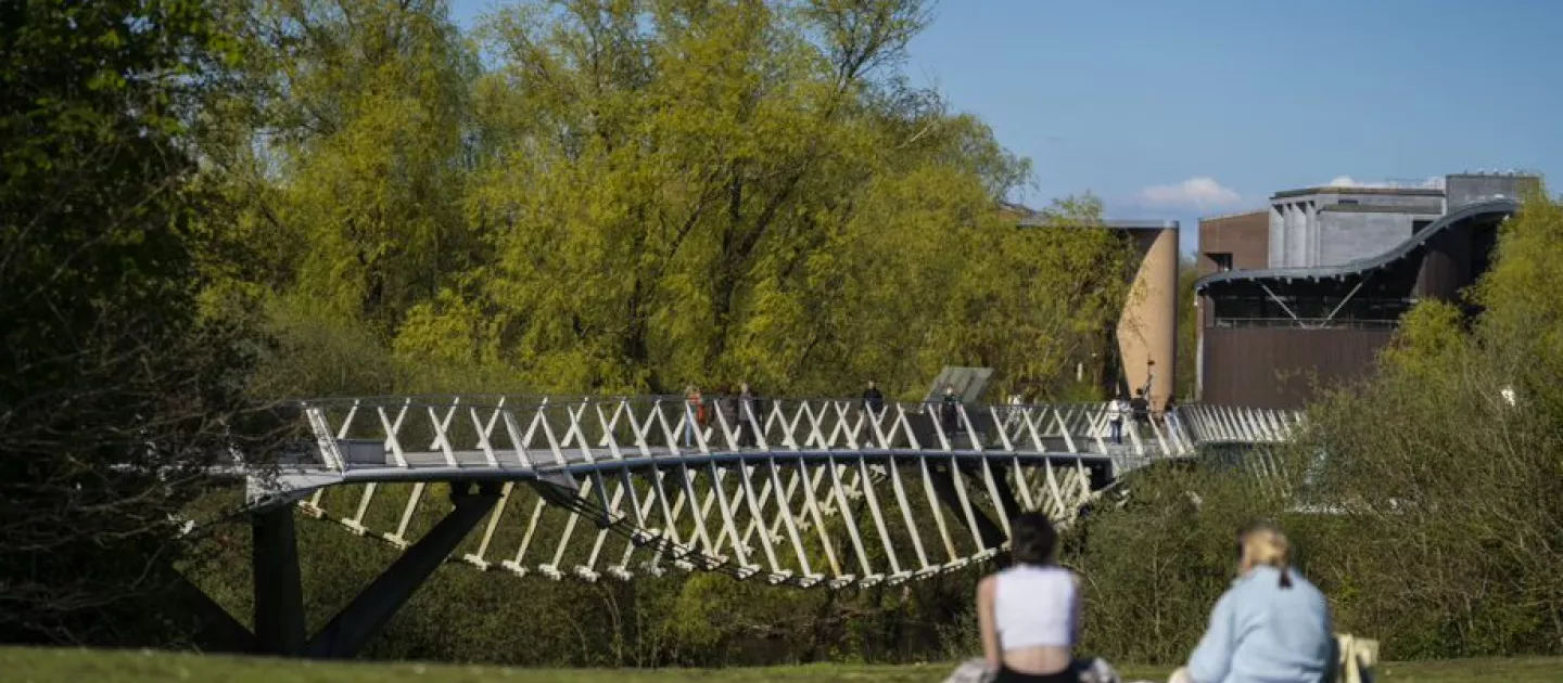 girls looking at metal bridge