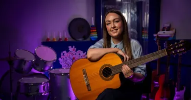Image of Alison Sweeney, Music Therapist, holding a guitar