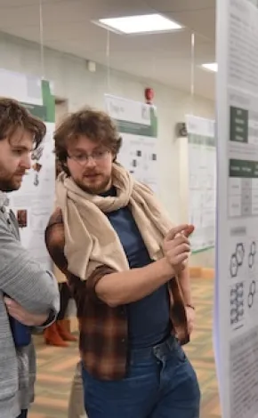 Two menu looking at a poster