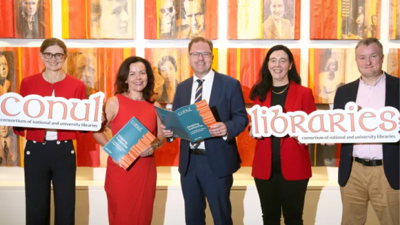 people holding a strategy document and conul signs