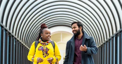 Two people walking a corridor
