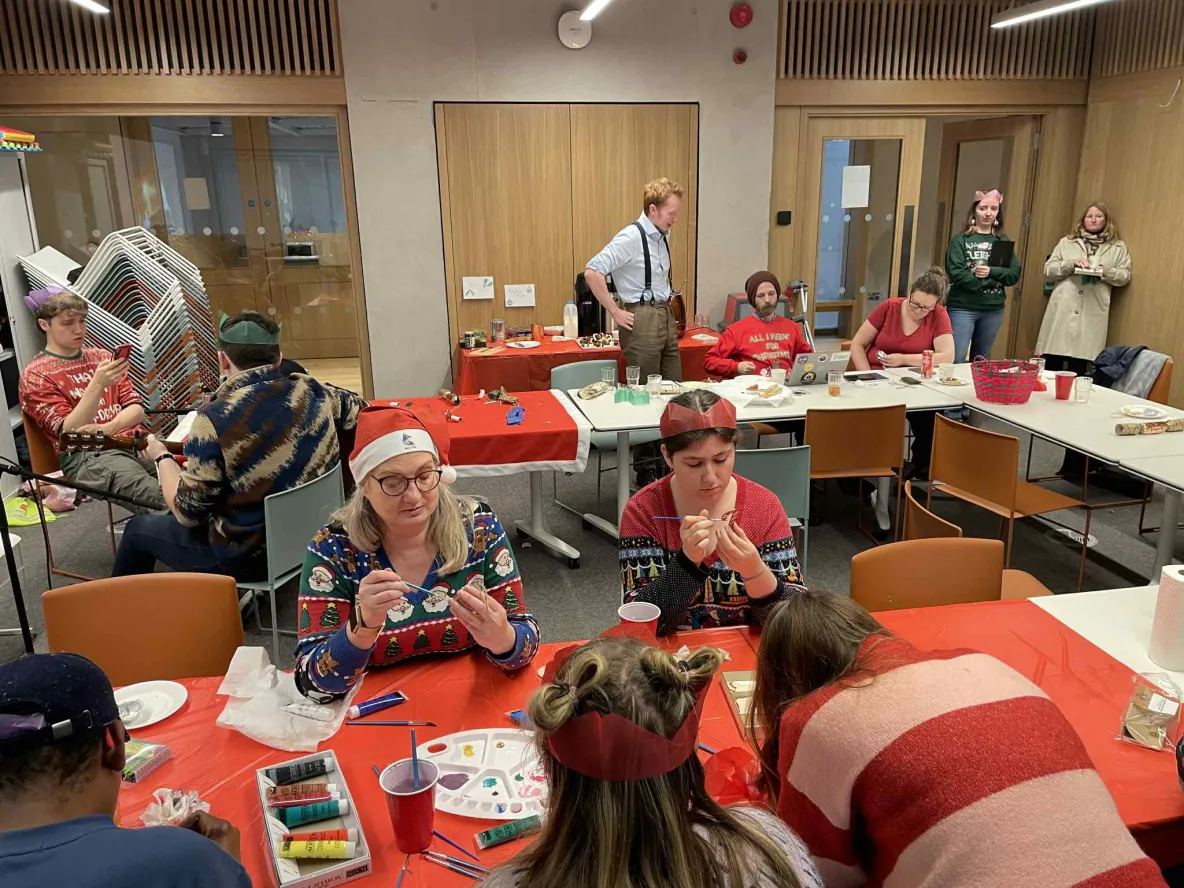 Dot Madden pictured with mature students painting Xmas decorations