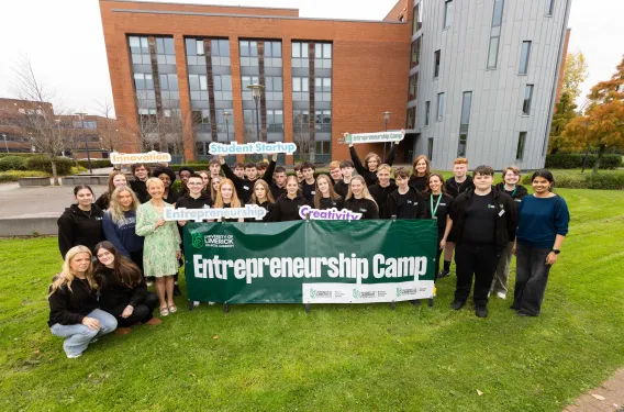 group of males and females outside a building