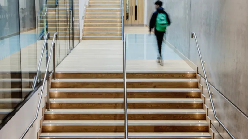 student on wooden staircase