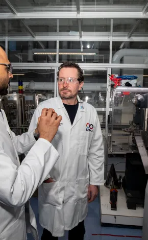 Process lab scientists discussing freeze drying equipment