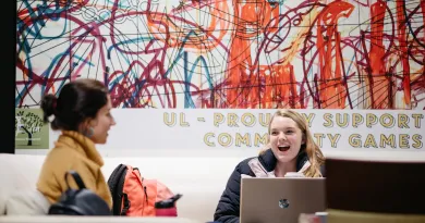 Two students laughing outside of Eden on UL Campus
